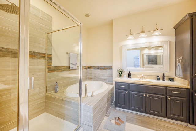 bathroom featuring vanity and separate shower and tub