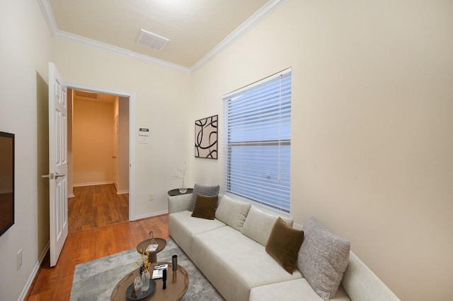 living room featuring wood-type flooring and ornamental molding