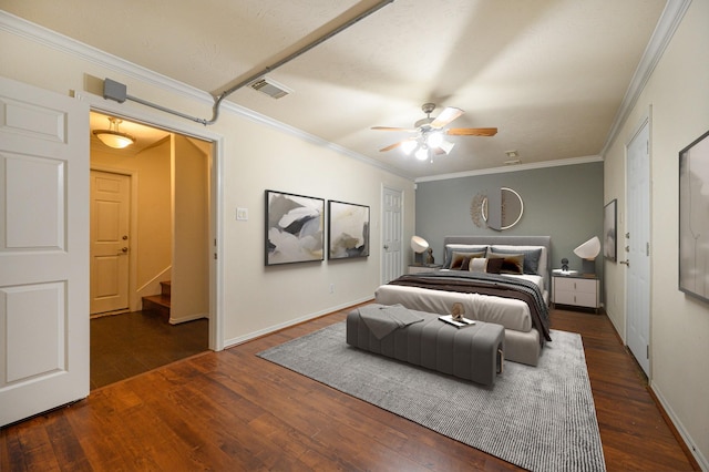 bedroom with ceiling fan, ornamental molding, and dark wood-type flooring