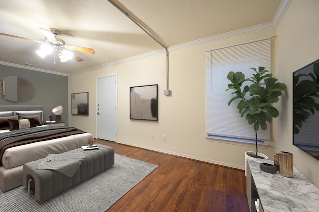 bedroom featuring dark hardwood / wood-style flooring, ceiling fan, and crown molding