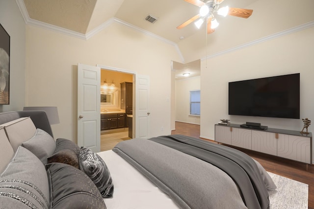 bedroom with ensuite bath, ceiling fan, light hardwood / wood-style flooring, crown molding, and vaulted ceiling