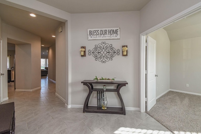 hall featuring light tile patterned flooring