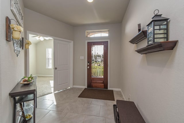 foyer entrance featuring ceiling fan