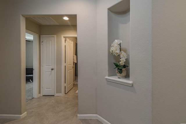 hall with light tile patterned flooring