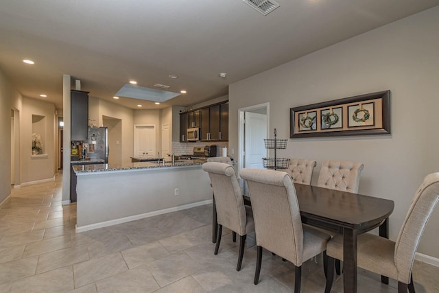 dining area with light tile patterned flooring and sink