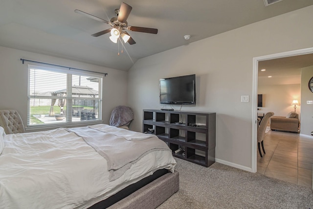 bedroom featuring ceiling fan, lofted ceiling, and light tile patterned floors