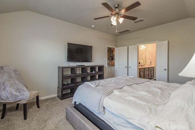 bedroom featuring light colored carpet, vaulted ceiling, ceiling fan, and ensuite bathroom