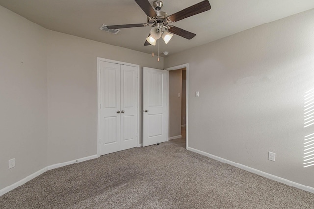 unfurnished bedroom with carpet flooring, ceiling fan, and a closet