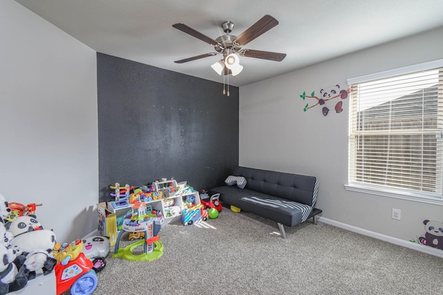 playroom featuring carpet and ceiling fan