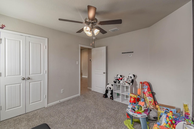 playroom featuring ceiling fan and carpet floors