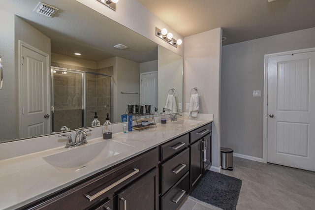 bathroom with tile patterned floors, vanity, and walk in shower