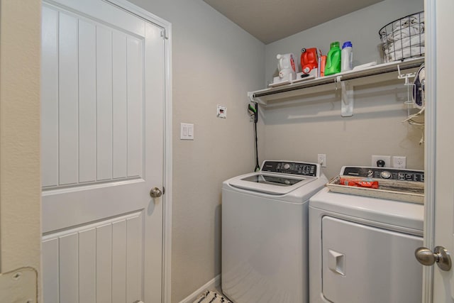 clothes washing area featuring separate washer and dryer