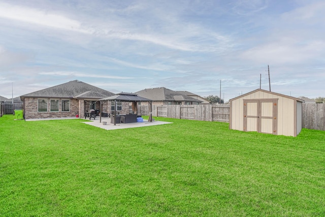 view of yard with a gazebo, a patio, and a storage shed