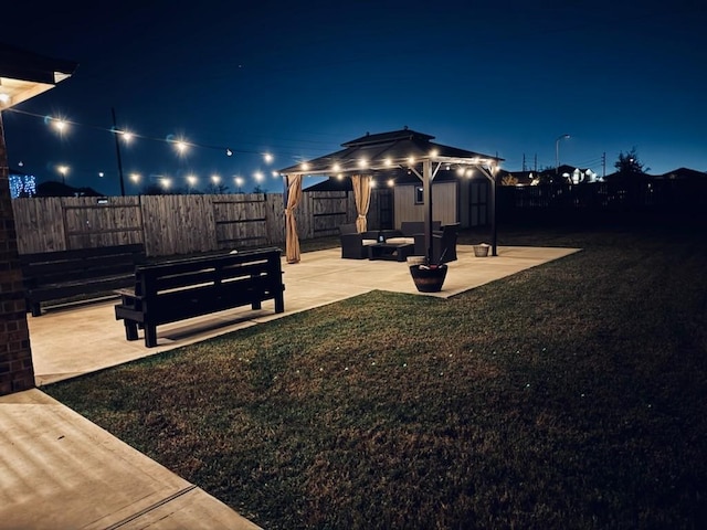 view of yard featuring a patio, an outdoor hangout area, and a storage unit