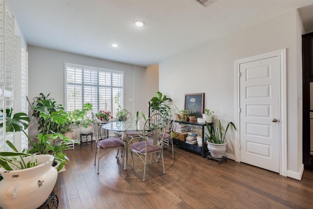 dining room with dark hardwood / wood-style flooring