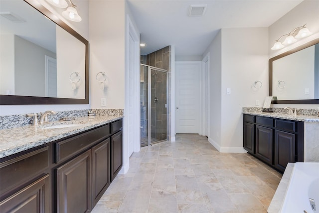 bathroom featuring vanity and a shower with shower door