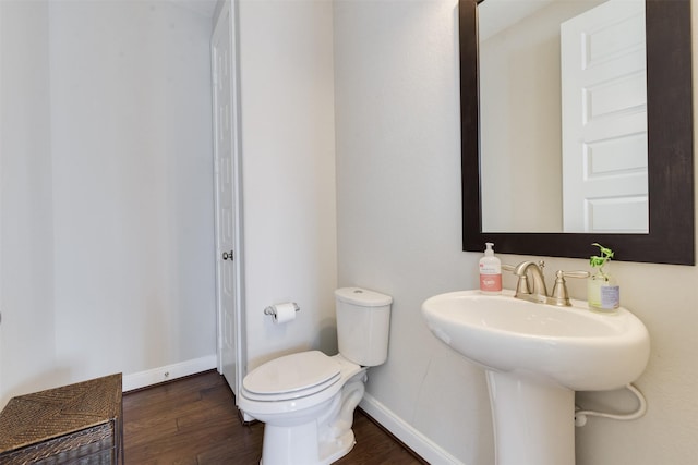 bathroom featuring hardwood / wood-style flooring, toilet, and sink