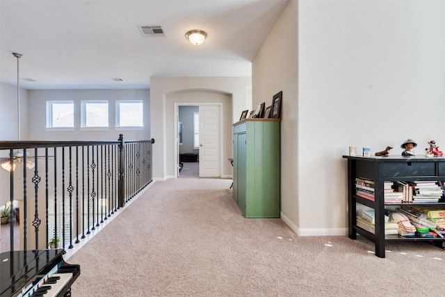 hall featuring light colored carpet