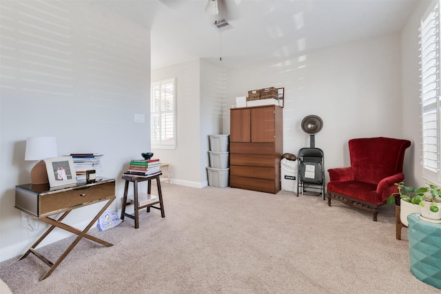 sitting room featuring light carpet