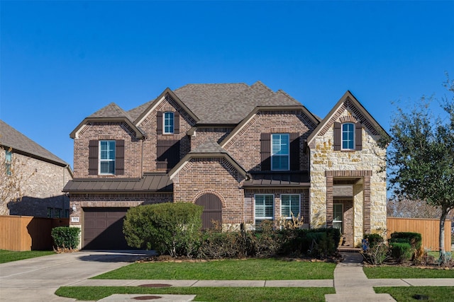 view of front of house with a garage and a front yard