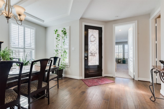 entryway featuring wood-type flooring and a notable chandelier