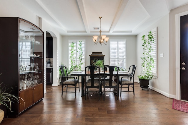 dining space with dark hardwood / wood-style flooring, plenty of natural light, and a notable chandelier