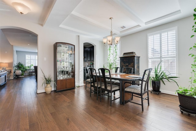 dining room featuring dark hardwood / wood-style floors and an inviting chandelier