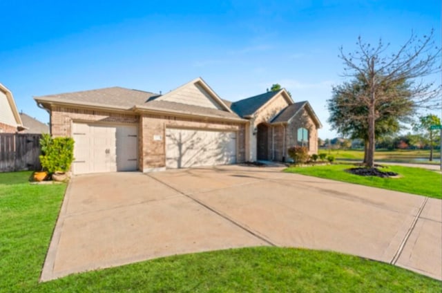 ranch-style house featuring a garage and a front yard