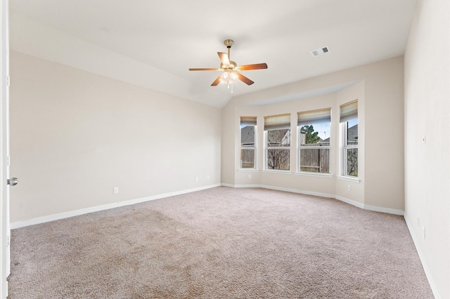 carpeted spare room with ceiling fan and lofted ceiling