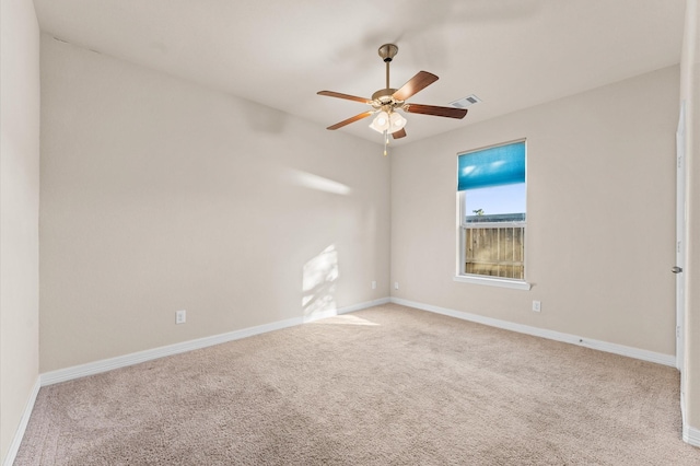 spare room featuring ceiling fan and light colored carpet