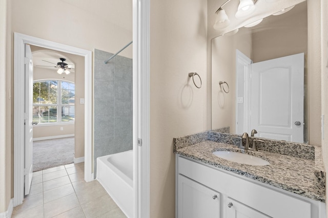 bathroom with vanity, tile patterned floors, ceiling fan, and tiled shower / bath combo