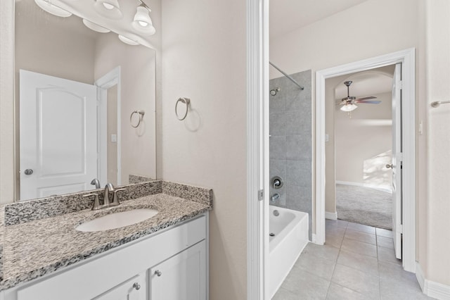 bathroom featuring tile patterned flooring, tiled shower / bath, vanity, and ceiling fan