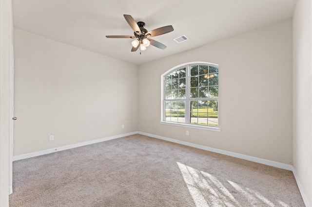 unfurnished room featuring ceiling fan and light colored carpet