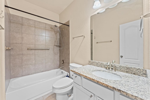 full bathroom with tile patterned floors, toilet, vanity, and tiled shower / bath