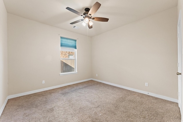 carpeted spare room with ceiling fan