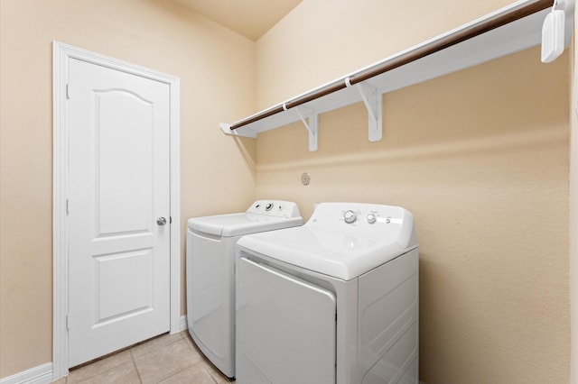 washroom with independent washer and dryer and light tile patterned flooring