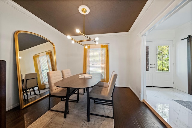 dining space with dark wood-type flooring, a barn door, a notable chandelier, crown molding, and a textured ceiling