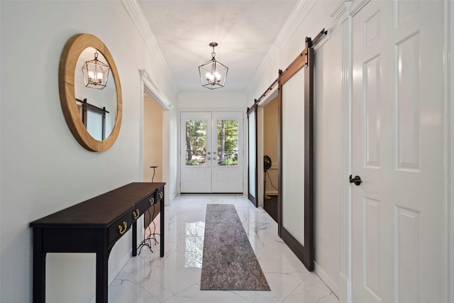 entryway featuring a barn door, crown molding, french doors, and a chandelier