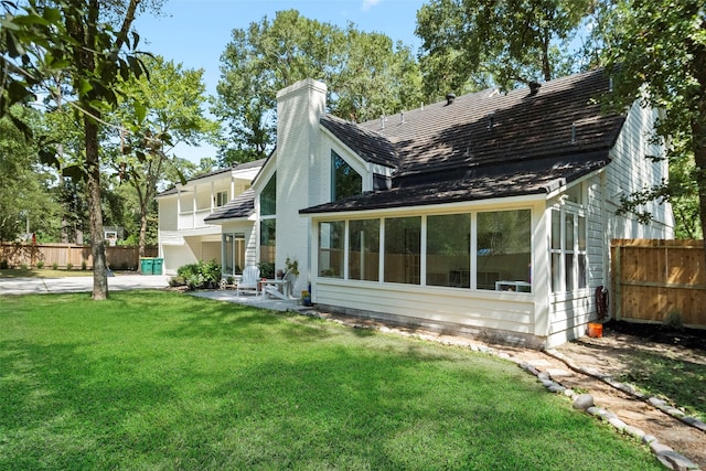 rear view of house with a patio area and a yard