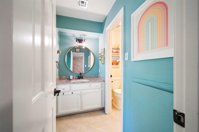 bathroom featuring vanity and toilet