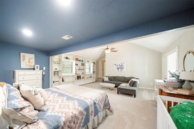 bedroom featuring light colored carpet and lofted ceiling