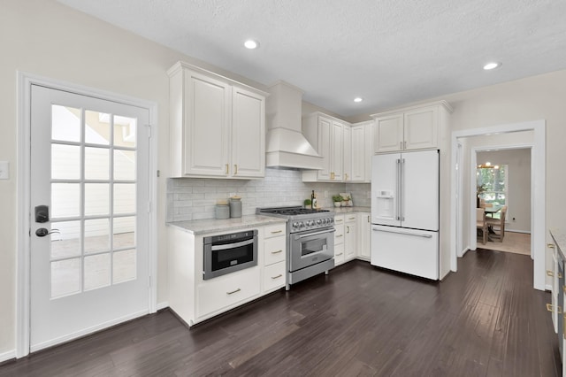 kitchen featuring high quality appliances, custom exhaust hood, dark wood-style flooring, tasteful backsplash, and recessed lighting
