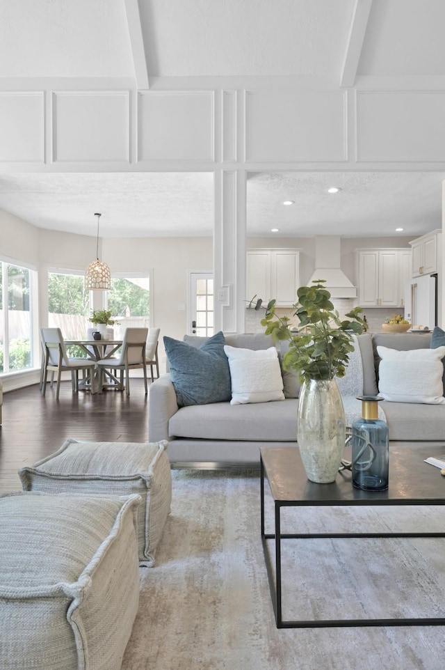 living room featuring wood finished floors, beamed ceiling, recessed lighting, and coffered ceiling
