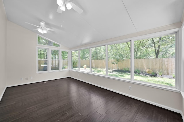 unfurnished sunroom with lofted ceiling, baseboards, and wood finished floors