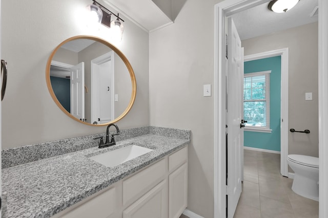 bathroom with tile patterned floors, baseboards, vanity, and toilet