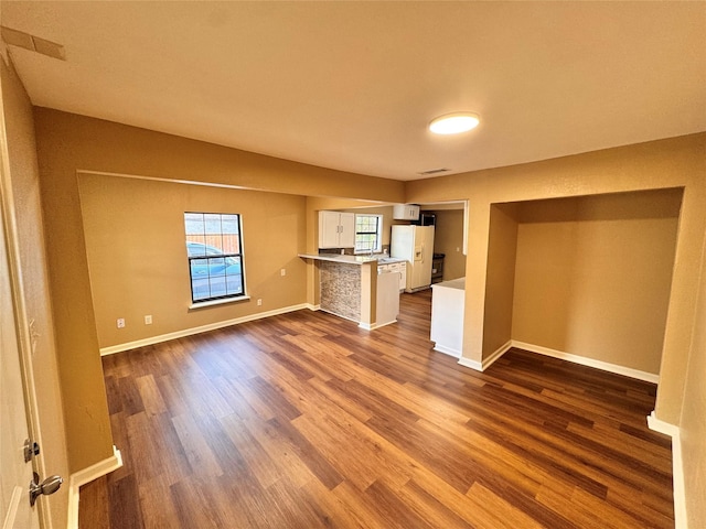 unfurnished living room featuring hardwood / wood-style floors