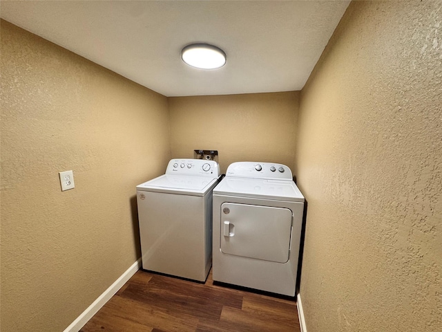 laundry area featuring independent washer and dryer and dark hardwood / wood-style flooring