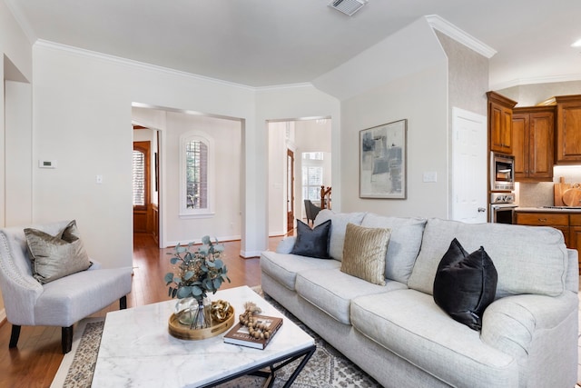 living room with hardwood / wood-style flooring and crown molding