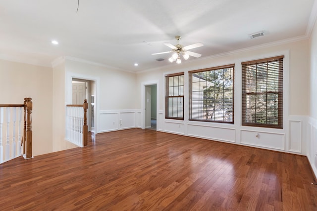 spare room featuring ceiling fan, wood-type flooring, and ornamental molding