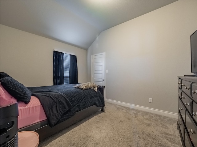 bedroom with light colored carpet and vaulted ceiling